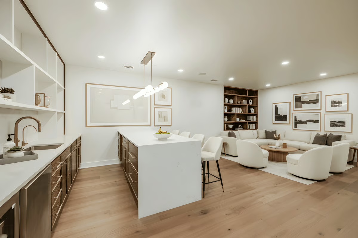 Professionally photographed lower-level lounge with kitchenette and custom finishes