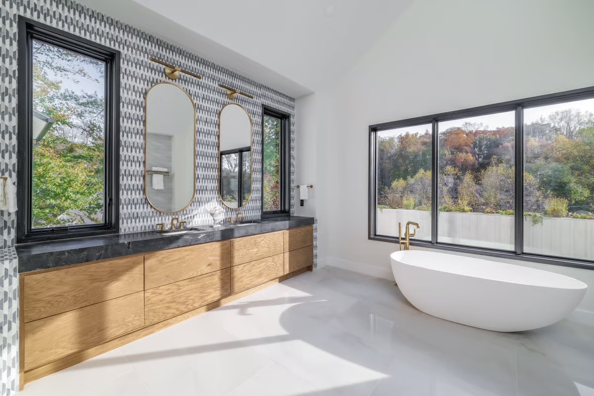 Professionally photographed primary bathroom with soaking tub and custom tile