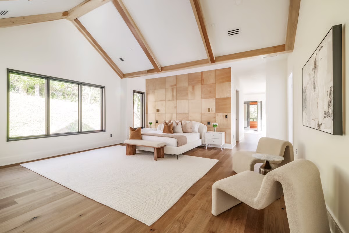 Professionally photographed primary bedroom with garden views