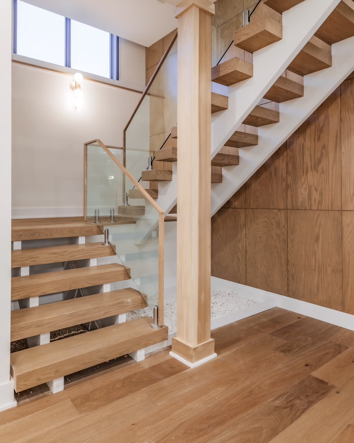 Custom glass and wood staircase in the Burning Tree home